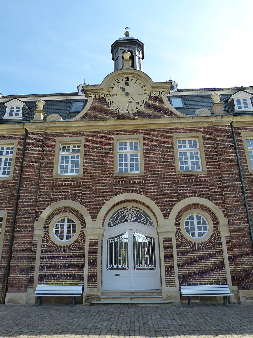 Historic Red Brick Building with Clock Tower and Arched Entrance