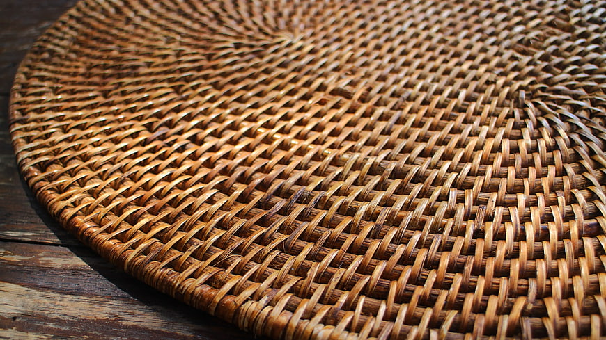 Close-up of Round Woven Wicker Placemat on Wood