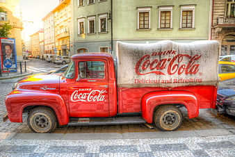 Vintage Red Coca-Cola Truck Parked on Cobblestone Street