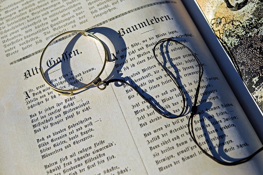 Vintage Magnifying Glass on Old German Poetry Book