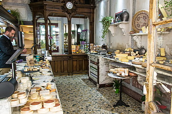 Interior of a traditional Parisian cheese shop with artisanal displays