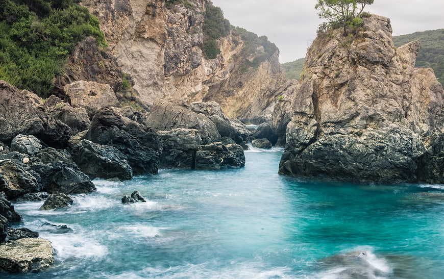 Turquoise Sea Water Flowing Through Rocky Coastal Cliffs
