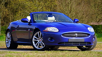 Blue Jaguar XK Convertible Parked on Gravel Road