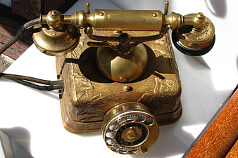 Antique Brass Candlestick Telephone on White Surface
