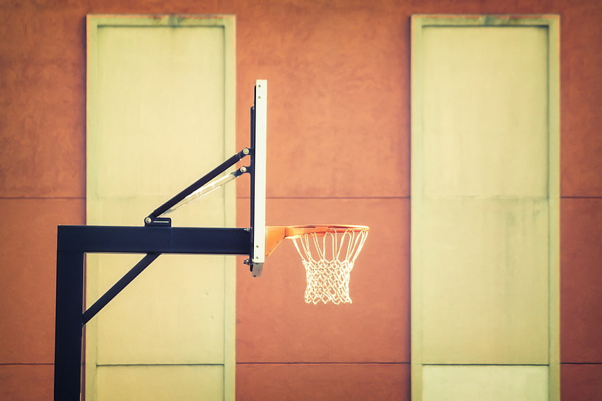 Basketball hoop against colorful urban wall background