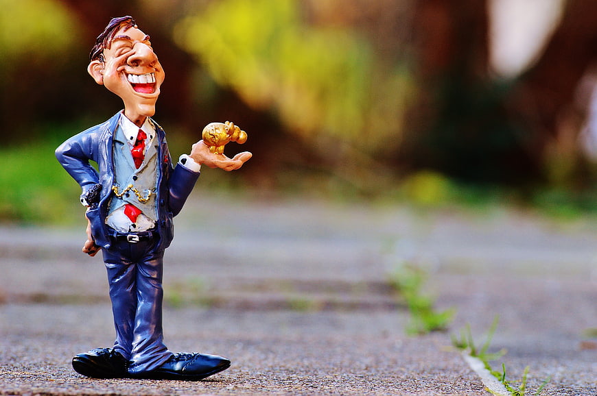Caricature Businessman Figurine Holding Euro Coin On Outdoor Path