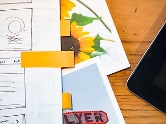 Creative Workspace with Sketchbook, Sunflower Photo, and Smartphone