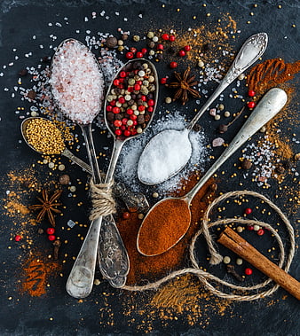 Top View of Spices and Herbs in Vintage Spoons on Slate