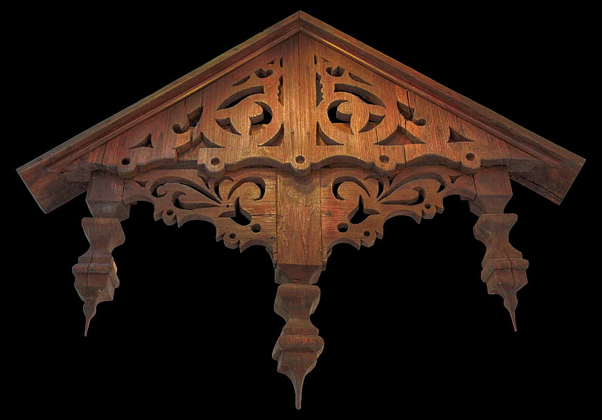 Ornate Carved Wooden Roof Bracket on Black Background