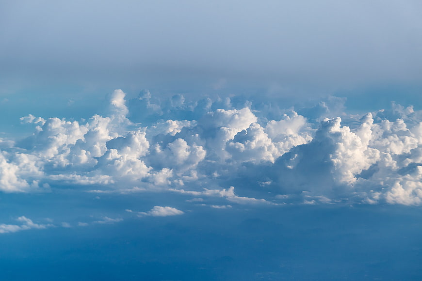 Dramatic Cumulus Clouds Against Blue Sky