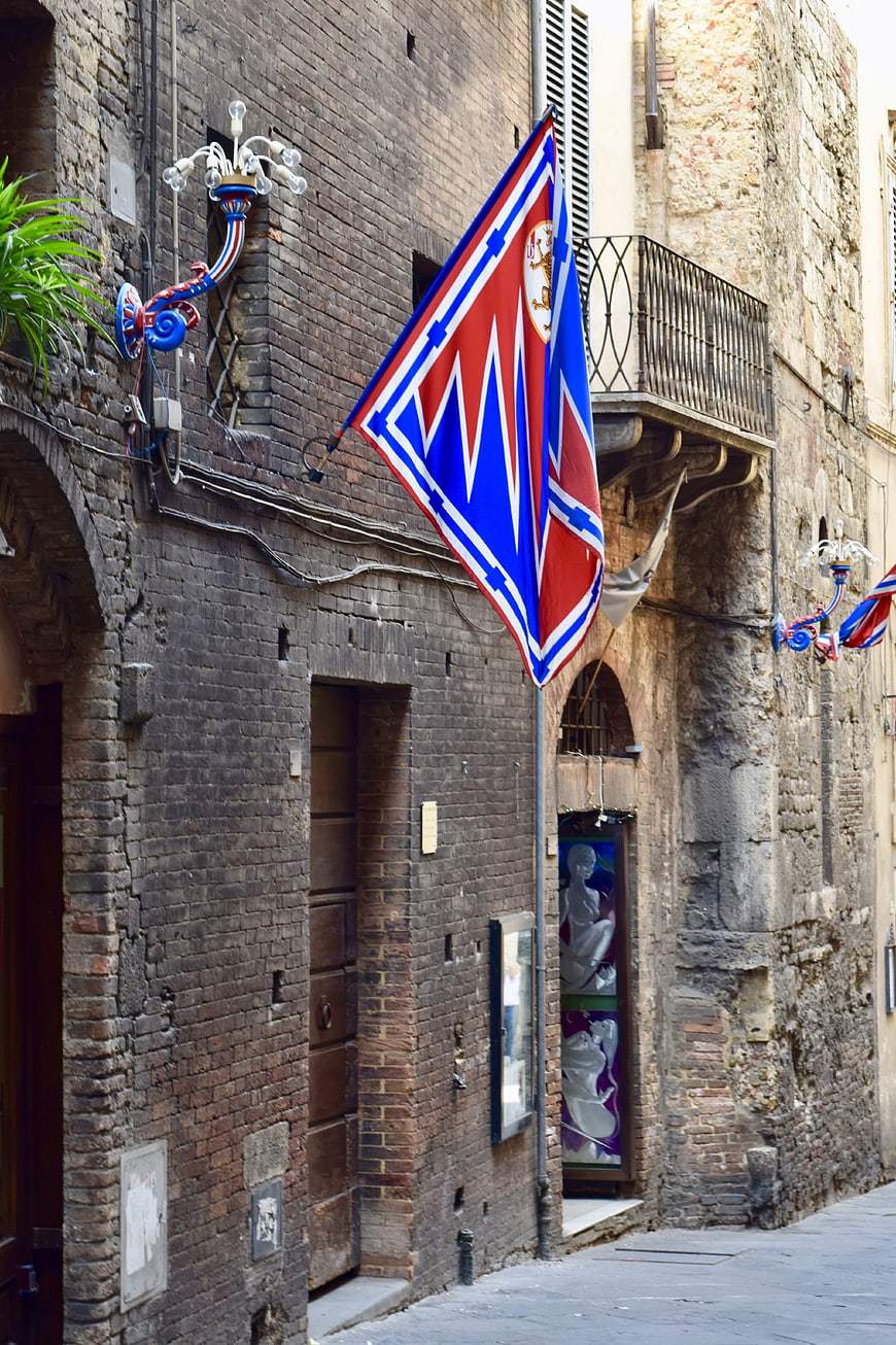 Historic Siena Street with Contrada Flag and Brick Architecture