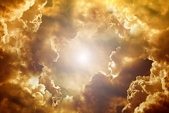 Dramatic golden clouds with sun rays breaking through