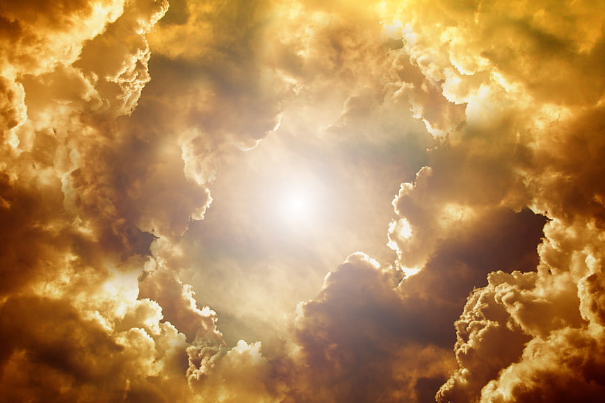Dramatic golden clouds with sun rays breaking through
