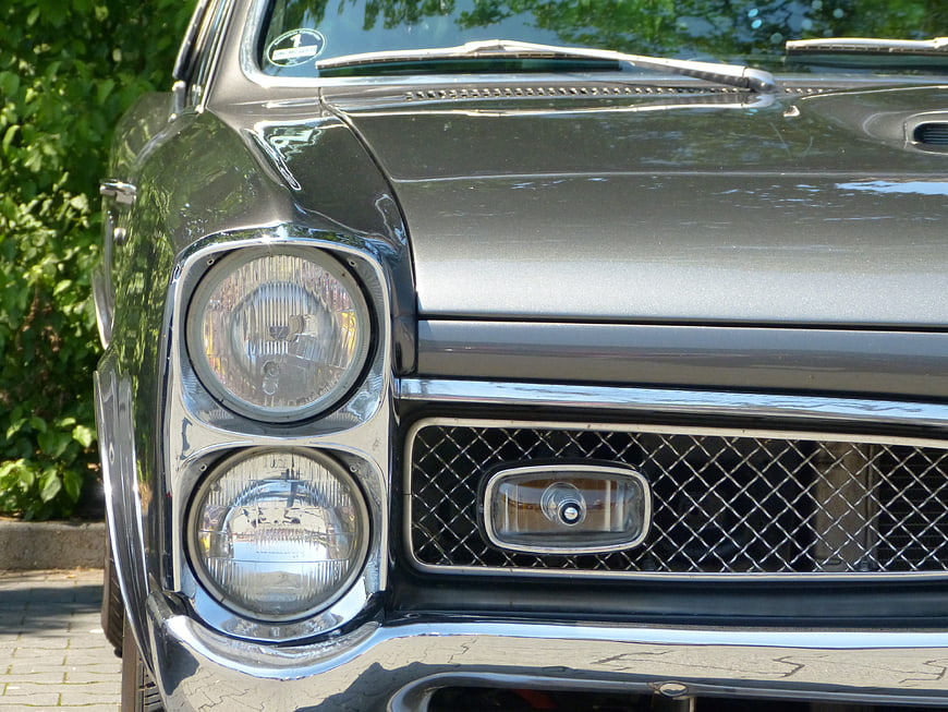 Close-up of vintage American car front grille and headlights