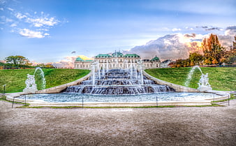 Grand Palace with Cascading Fountain and Autumn Sky