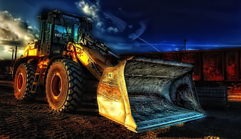 Yellow Caterpillar Wheel Loader on Construction Site at Dusk