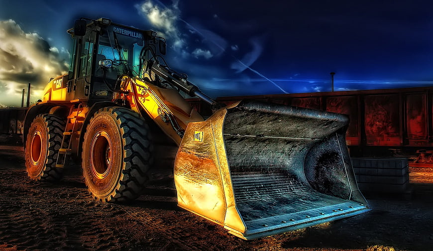 Yellow Caterpillar Wheel Loader on Construction Site at Dusk