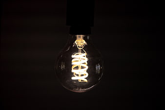 Illuminated Vintage Light Bulb on Dark Background