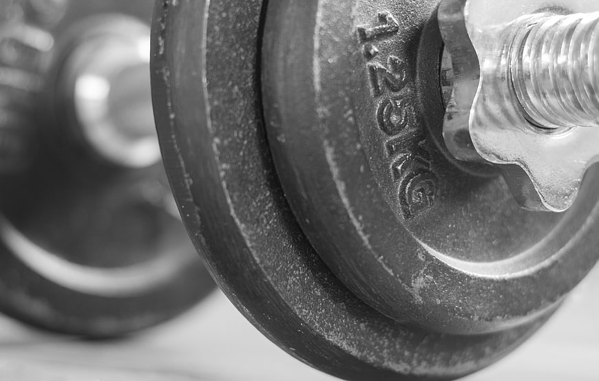 Black and white close-up of a 1.25kg dumbbell weight plate