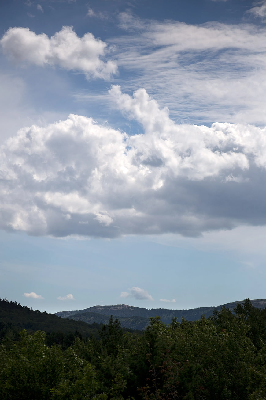 Dramatic Clouds Over Green Mountain Forest Landscape