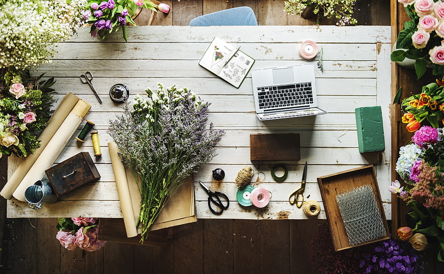 Floral Workspace Flat Lay With Laptop, Tools, And Fresh Flowers