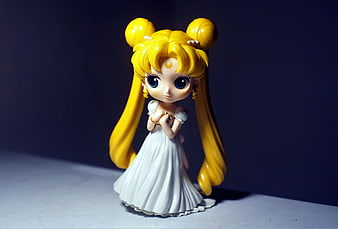 Sailor Moon Chibi Figure in White Dress on Dark Background