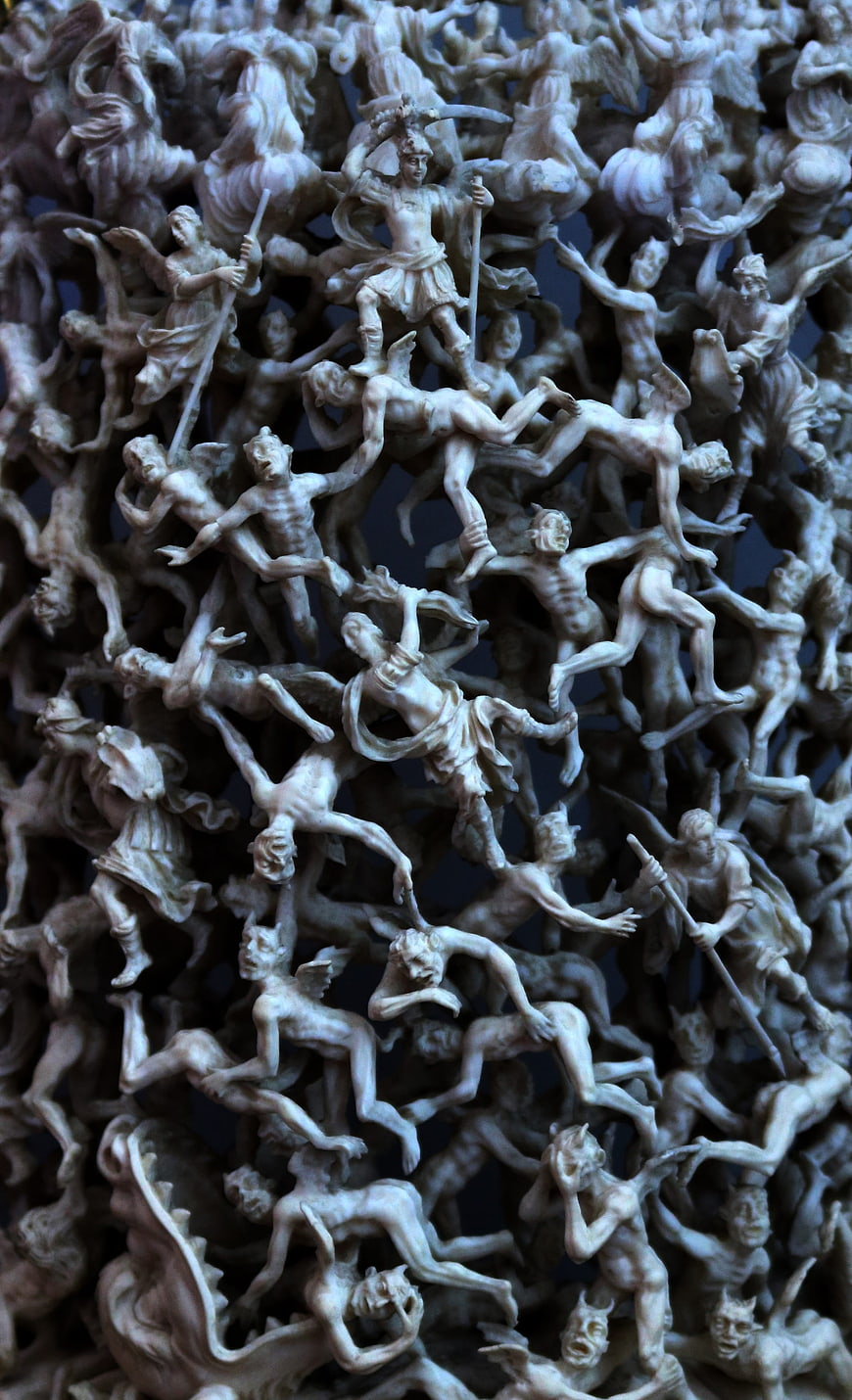 Intricate ivory carving of demons and devils in hell