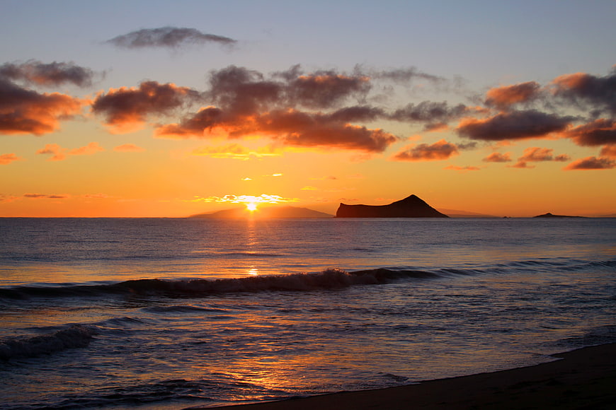 Golden Sunset Over Ocean with Silhouetted Island