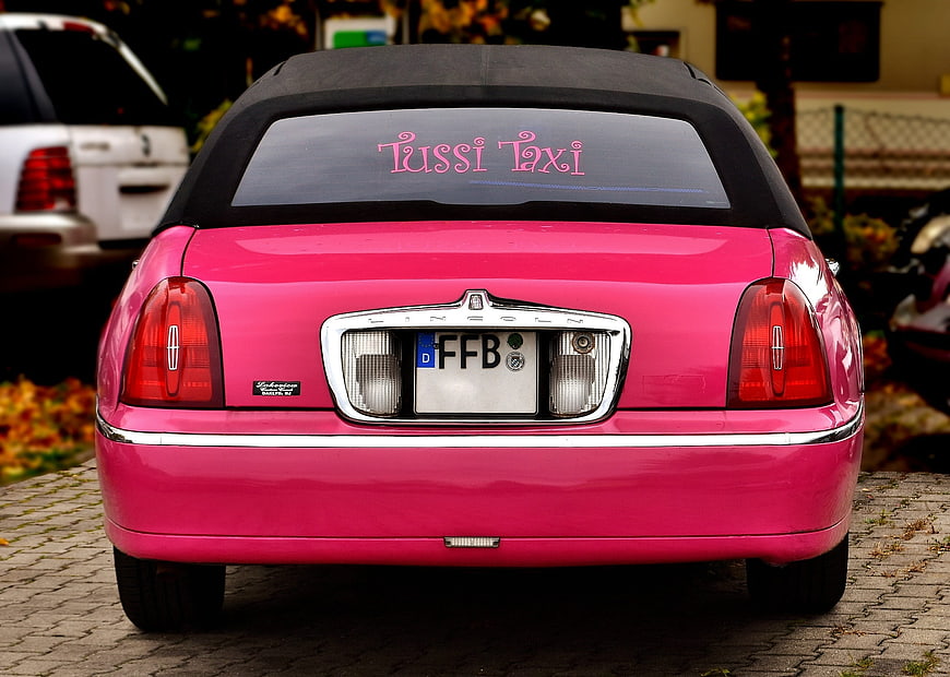 Rear View Of Pink Lincoln Town Car Taxi With Tussi Taxi Decal