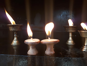 Traditional Nepali oil lamps and candles burning in a temple