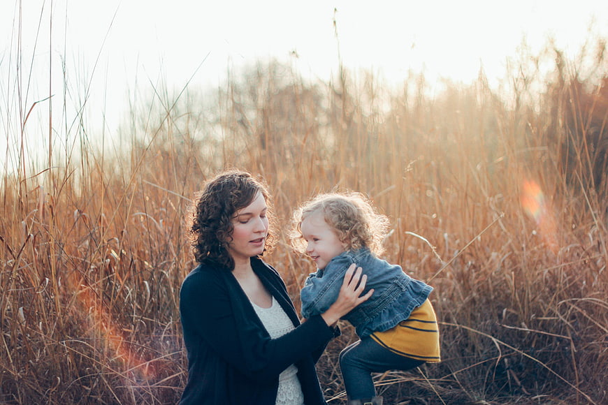 Mother and Toddler Playing in Golden Field at Sunset