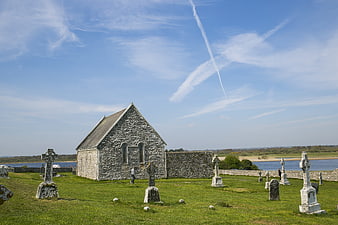Ancient stone church and graveyard by the sea in Ireland