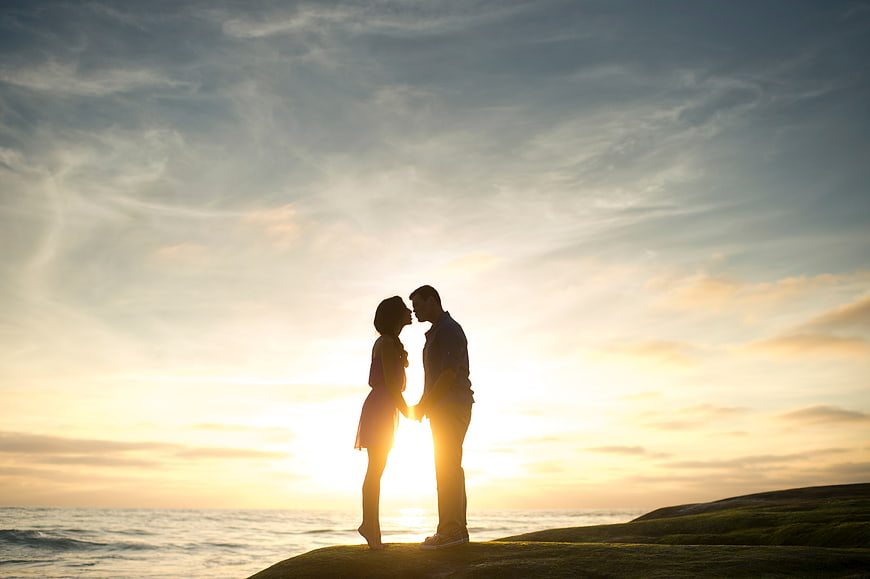 Silhouette of Romantic Couple About to Kiss at Sunset by the Ocean