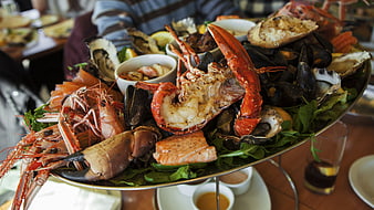 Gourmet seafood platter with lobster, prawns, and oysters