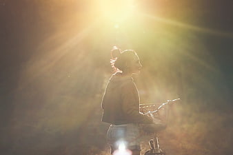 Backlit Woman with Bicycle in Golden Sunlight
