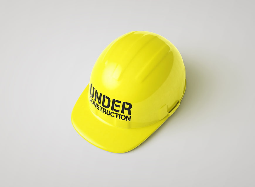 Yellow Hard Hat Under Construction Isolated on White Background