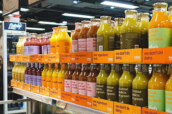 Colorful bottled fruit juices on supermarket shelves