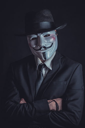 Anonymous Hacker in Suit and Fedora Mask