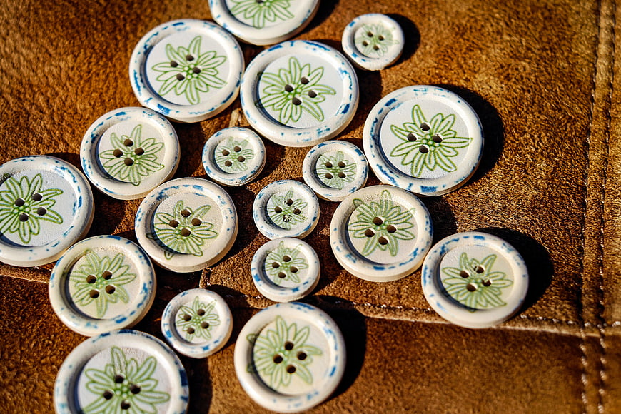 Vintage Floral Buttons on Brown Leather Texture