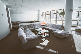 Spacious modern lounge with large sectional sofa and floor-to-ceiling windows