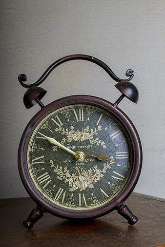 Vintage Brass Alarm Clock on Wooden Table