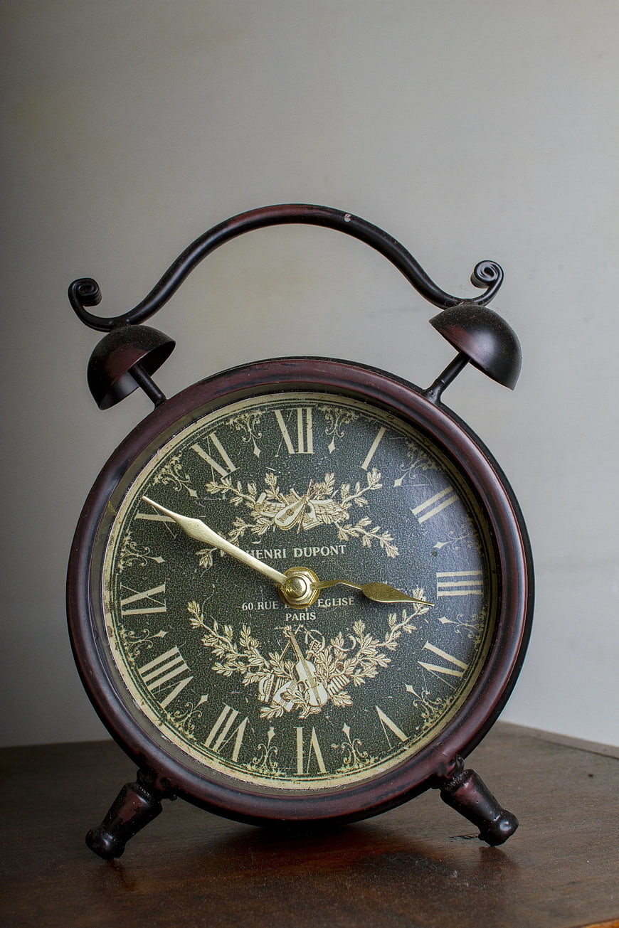Vintage Brass Alarm Clock on Wooden Table