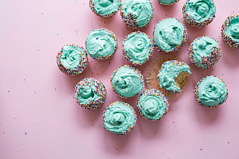 Top View of Mint Cupcakes with Sprinkles on Pink Background