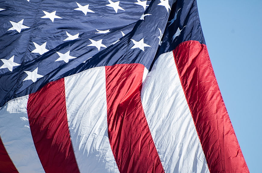 Close-up of American Flag Waving Against Clear Blue Sky