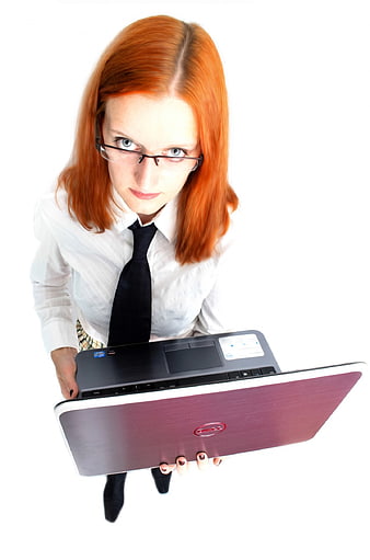 Red-haired businesswoman holding a laptop toward the camera