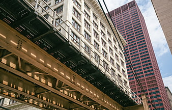 Low angle view of urban architecture and steel bridge structure