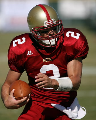 American Football Player in Red Uniform Running with Ball