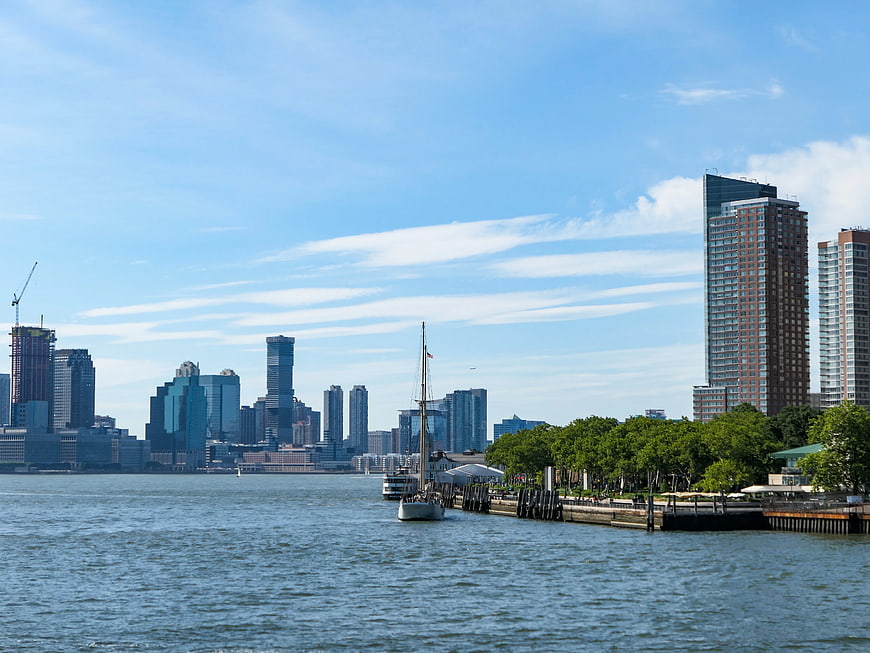 Sailboat on River with Manhattan Skyline and Park