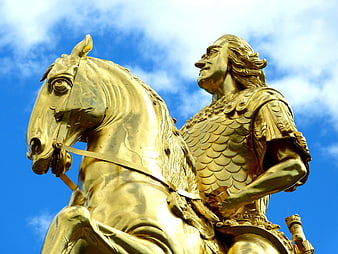 Golden Equestrian Statue Against Blue Sky