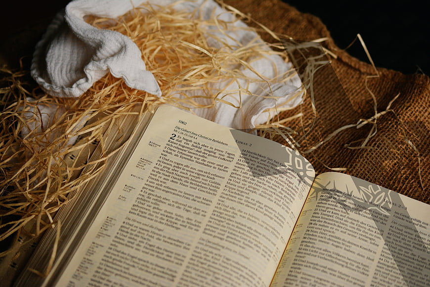 Open Bible with Straw and Cloth for Christmas Nativity